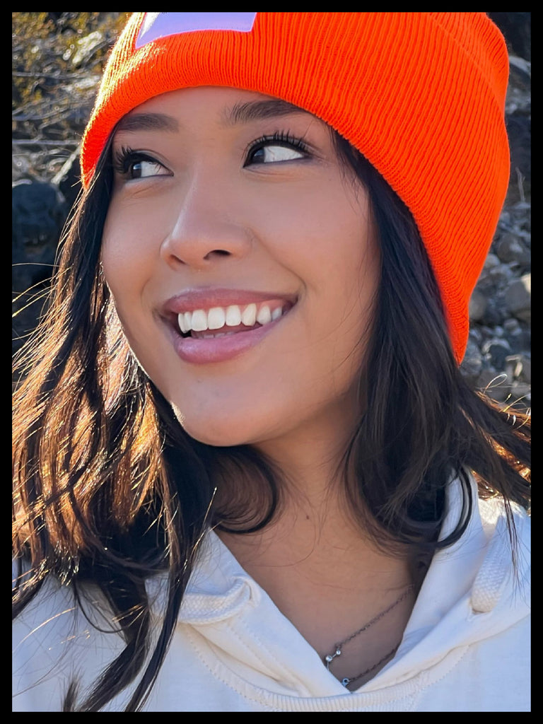 THE YEAR-ROUND BEANIE IN ORANGE SUNRISE w/ WHITE PATCH ON RACHEL THE BEAUTIFUL EARTH | Conscious Clothing Brand + Healthy Essentials
